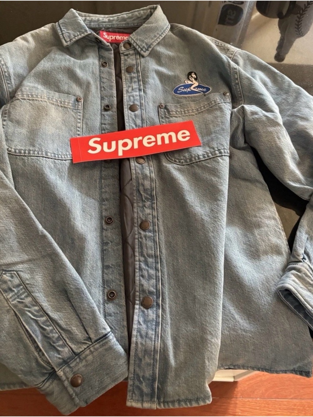 Supreme Light Wash Indigo Denim button down
Jacket with Red Logo Sticker